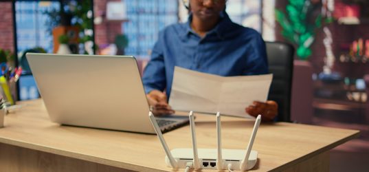 Young woman struggling with weak internet connection at home, pulling out LAN cable and adjusting Wi Fi settings to restore the signal. Female freelancer with technical issues. Camera A.